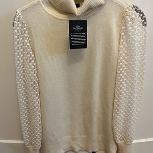 NWT Bloomingdale’s ivory cashmere sweater with sheer sleeve detail. Size small.